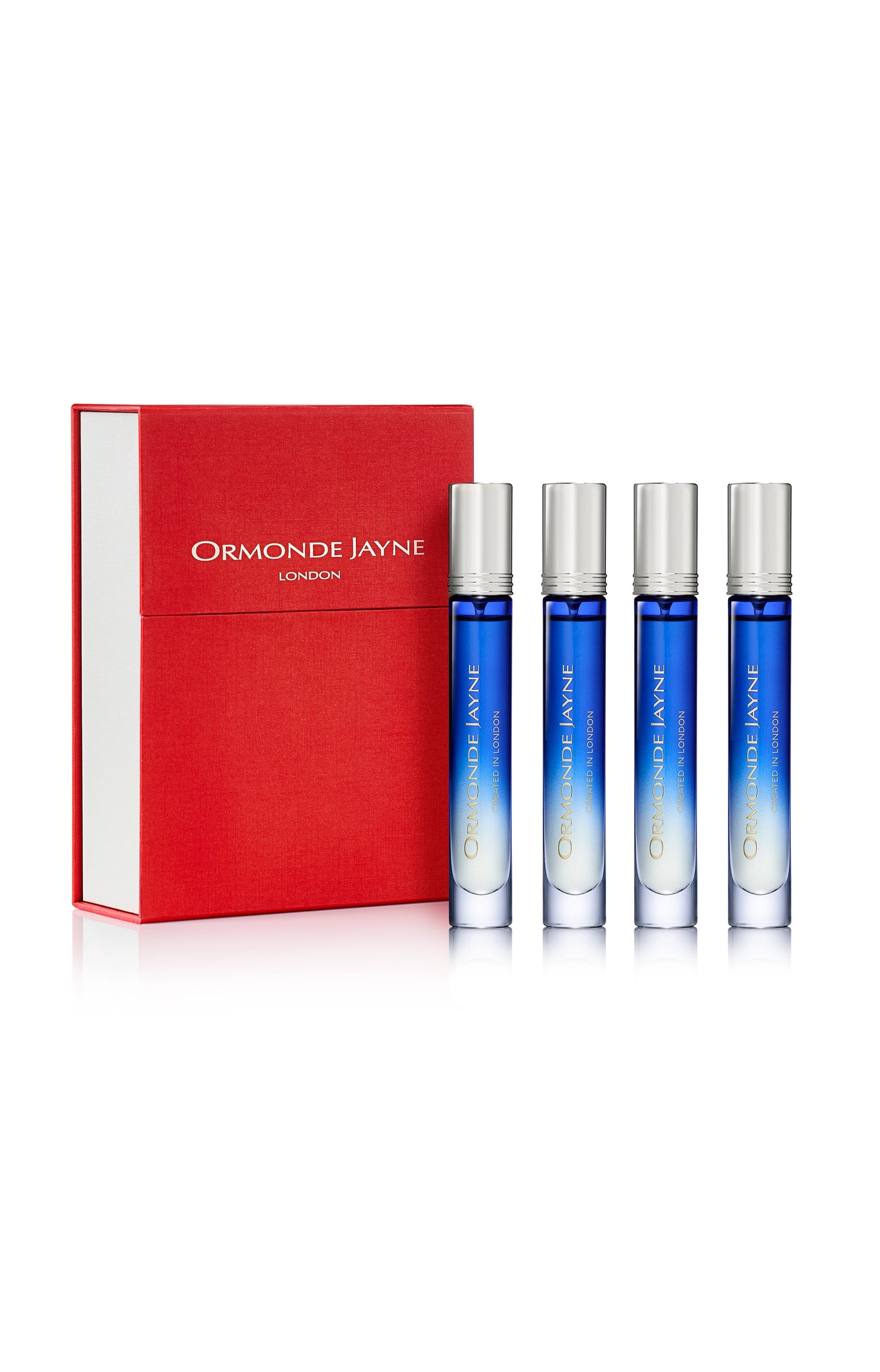 Set of four blue gradient glass perfume vials with silver caps beside a red and white Ormonde Jayne London box