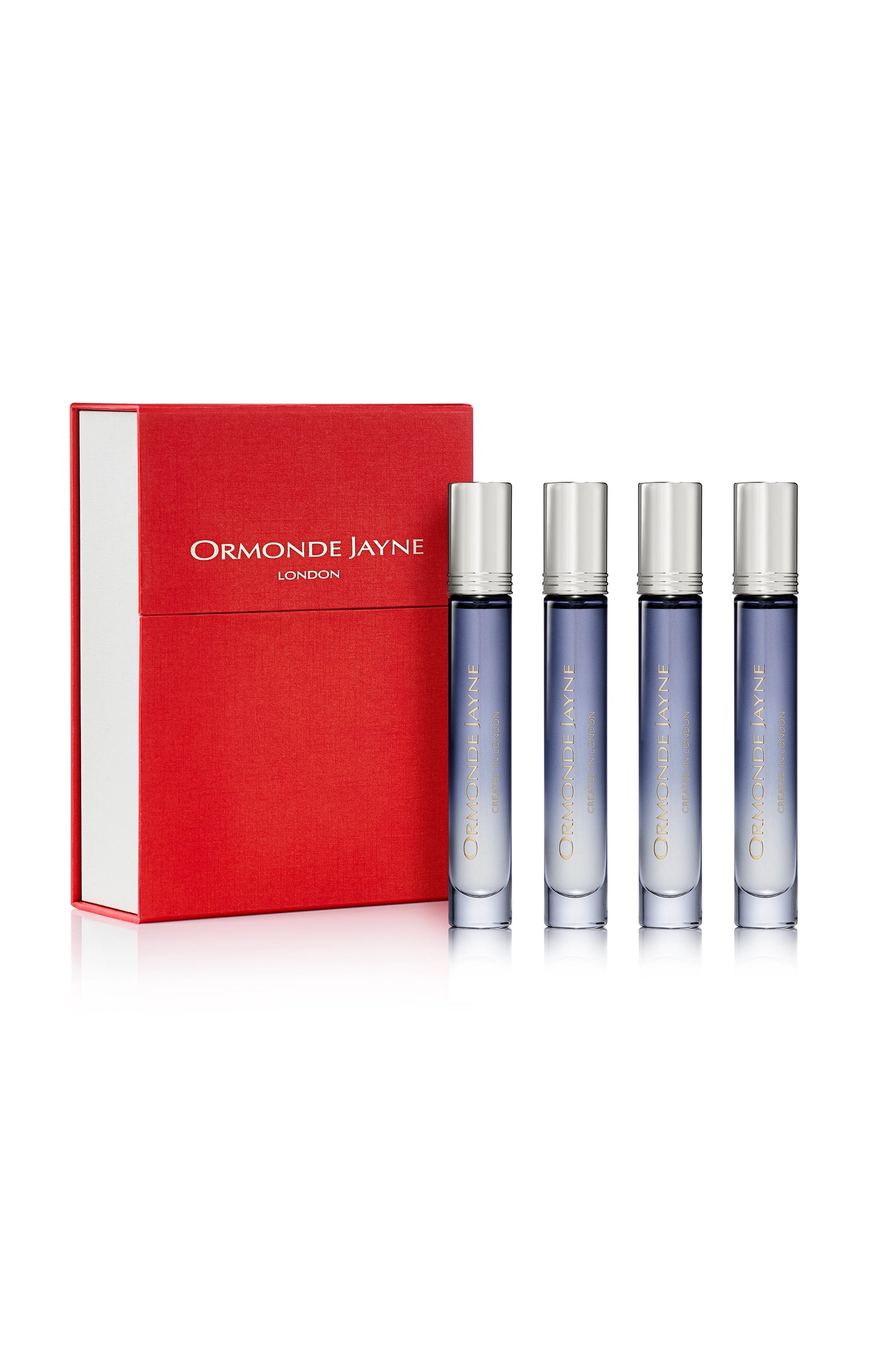 Set of four blue gradient glass travel perfume bottles with silver caps beside a red and white Ormonde Jayne London box
