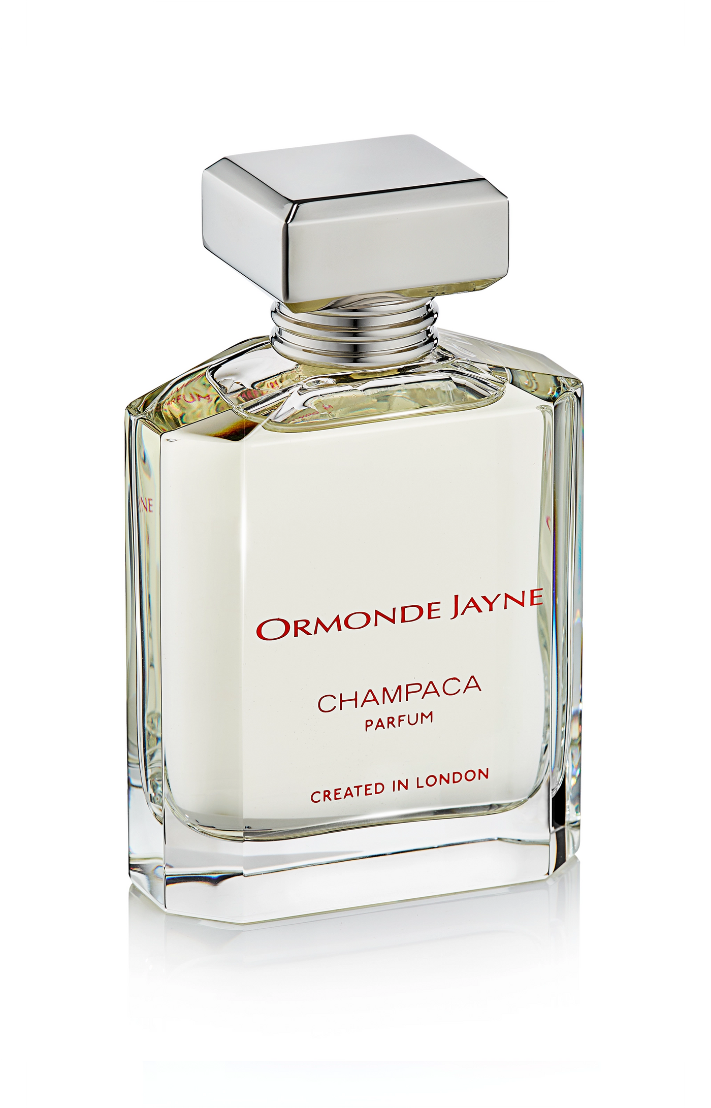 Clear glass perfume bottle with silver cap containing pale yellow Champaca parfum