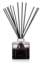 Black and clear glass reed diffuser bottle with black scent sticks, Ormonde Jayne branding