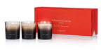 Set of three black and white gradient scented candles with floral fragrance in front of red Ormonde Jayne London box
