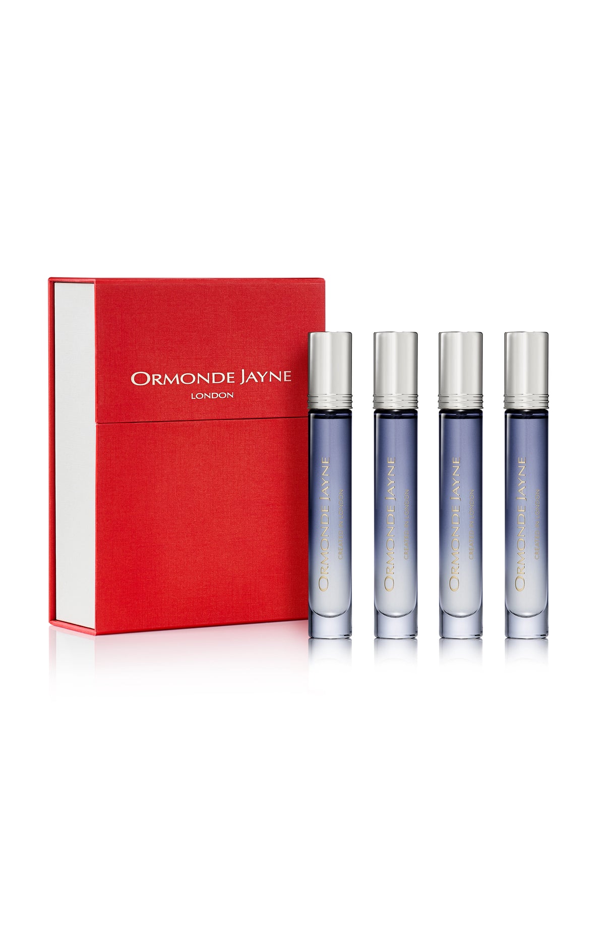 Set of four blue gradient glass travel perfume bottles with silver caps beside a red and white Ormonde Jayne London box