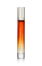 Tall slender glass perfume bottle with gradient amber to clear colour and silver cap