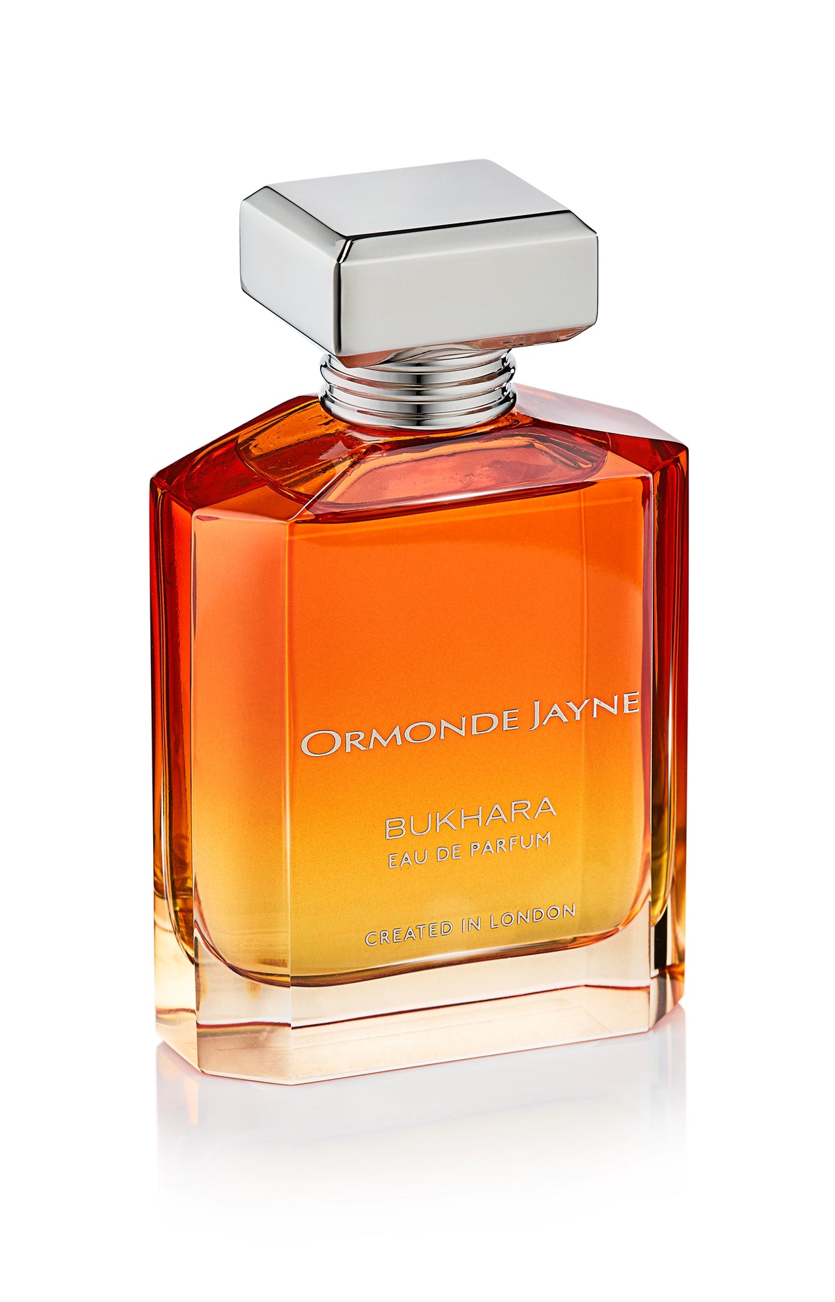 Rectangular glass perfume bottle with gradient amber to clear colour and silver cap