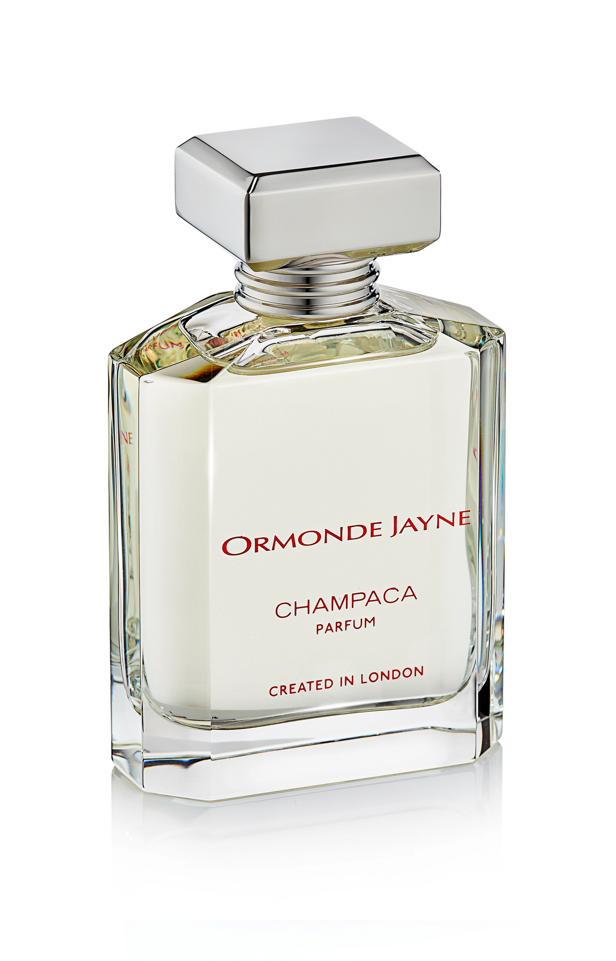 Clear glass perfume bottle with silver cap containing pale yellow Champaca parfum