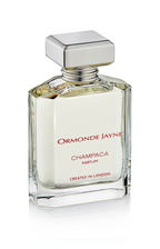 Clear glass perfume bottle with silver cap containing pale yellow Champaca parfum