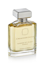Rectangular glass perfume bottle with silver cap containing golden liquid, labelled Nawab of Oudh Intensivo