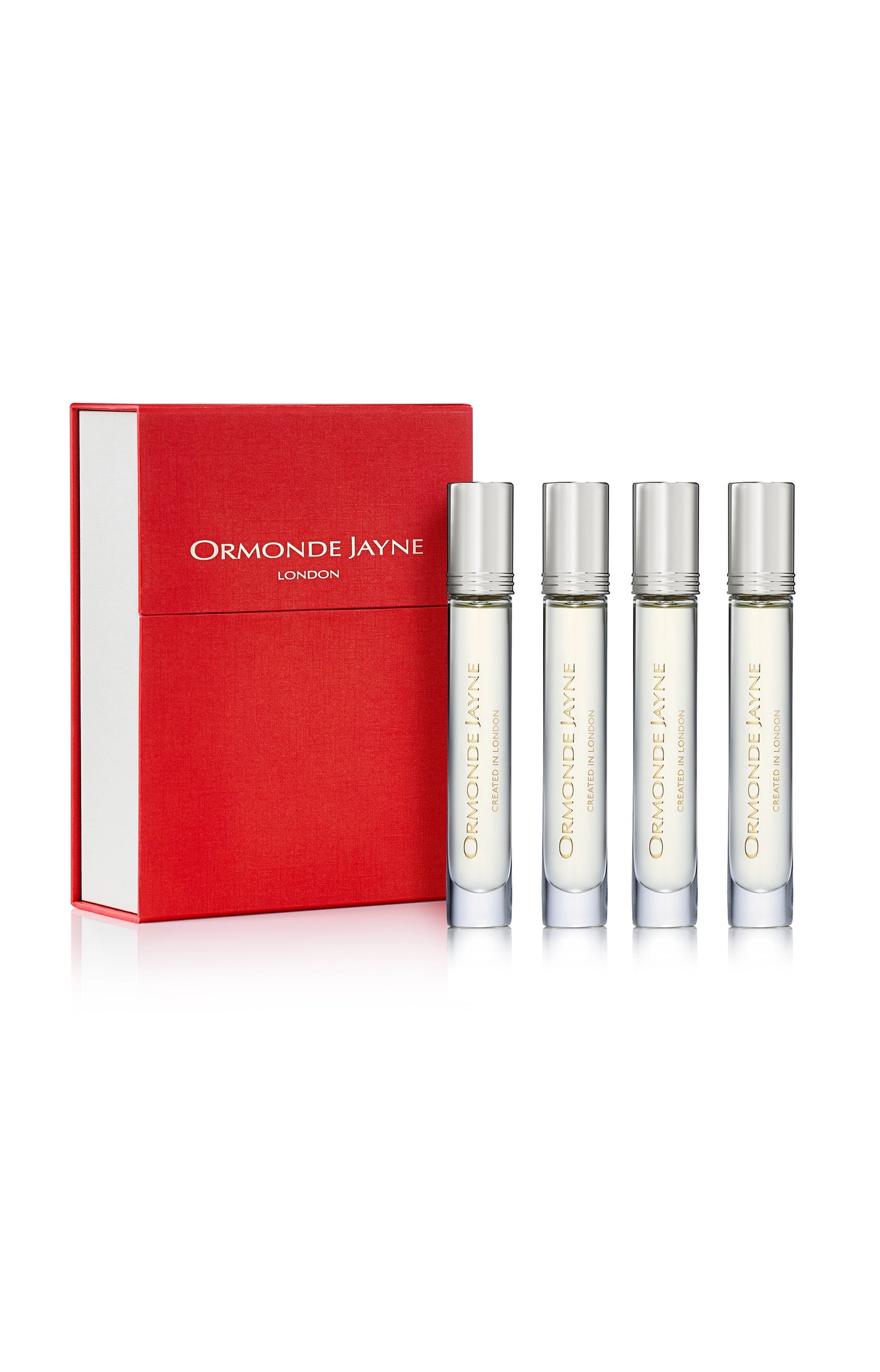Set of four clear glass perfume vials with silver caps alongside a red and white Ormonde Jayne London box