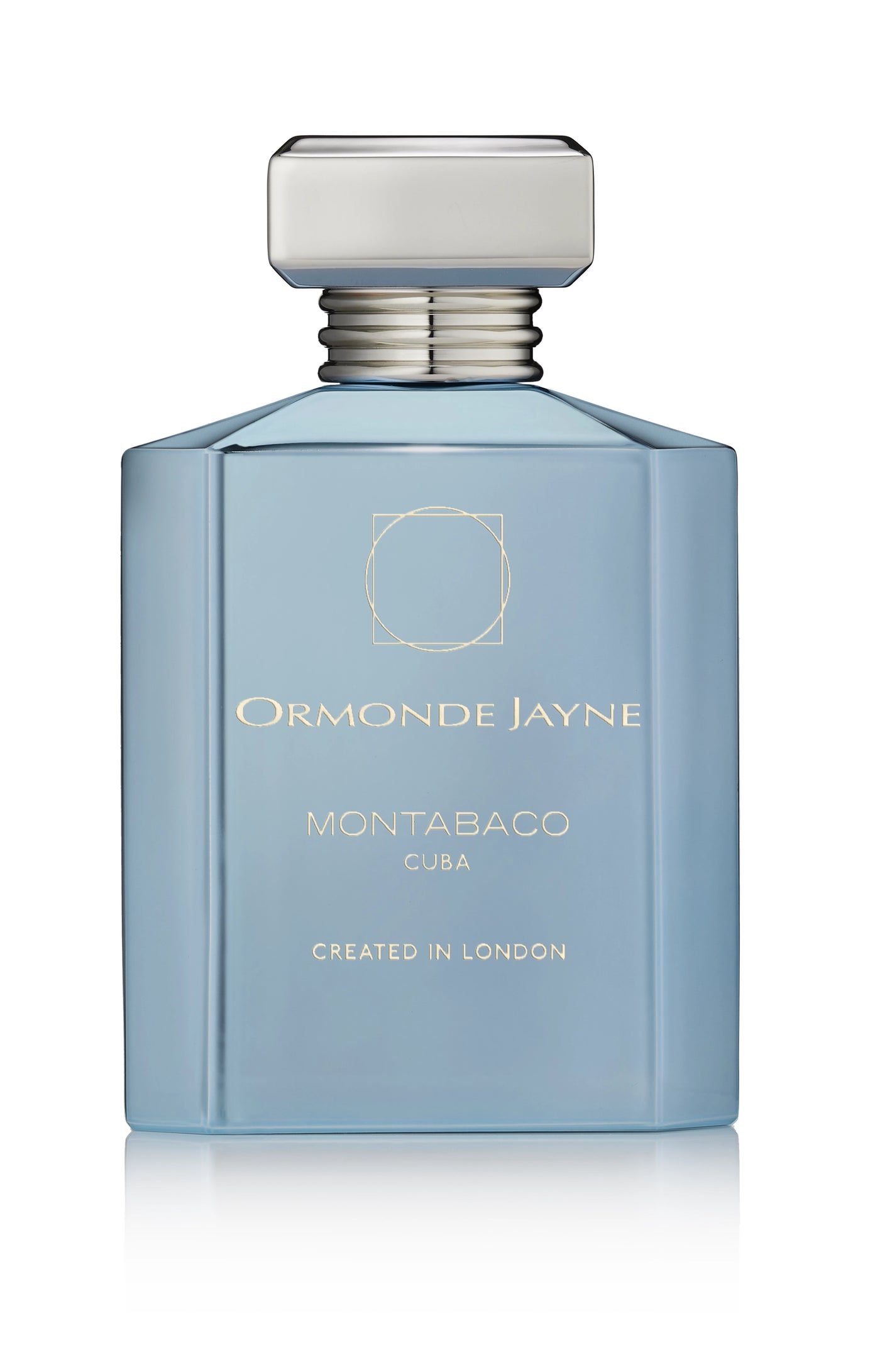 Light blue rectangular Montabaco Cuba perfume bottle with silver cap and gold lettering