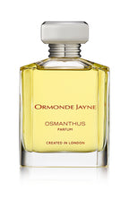 Clear glass perfume bottle with pale yellow Osmanthus fragrance and silver cap