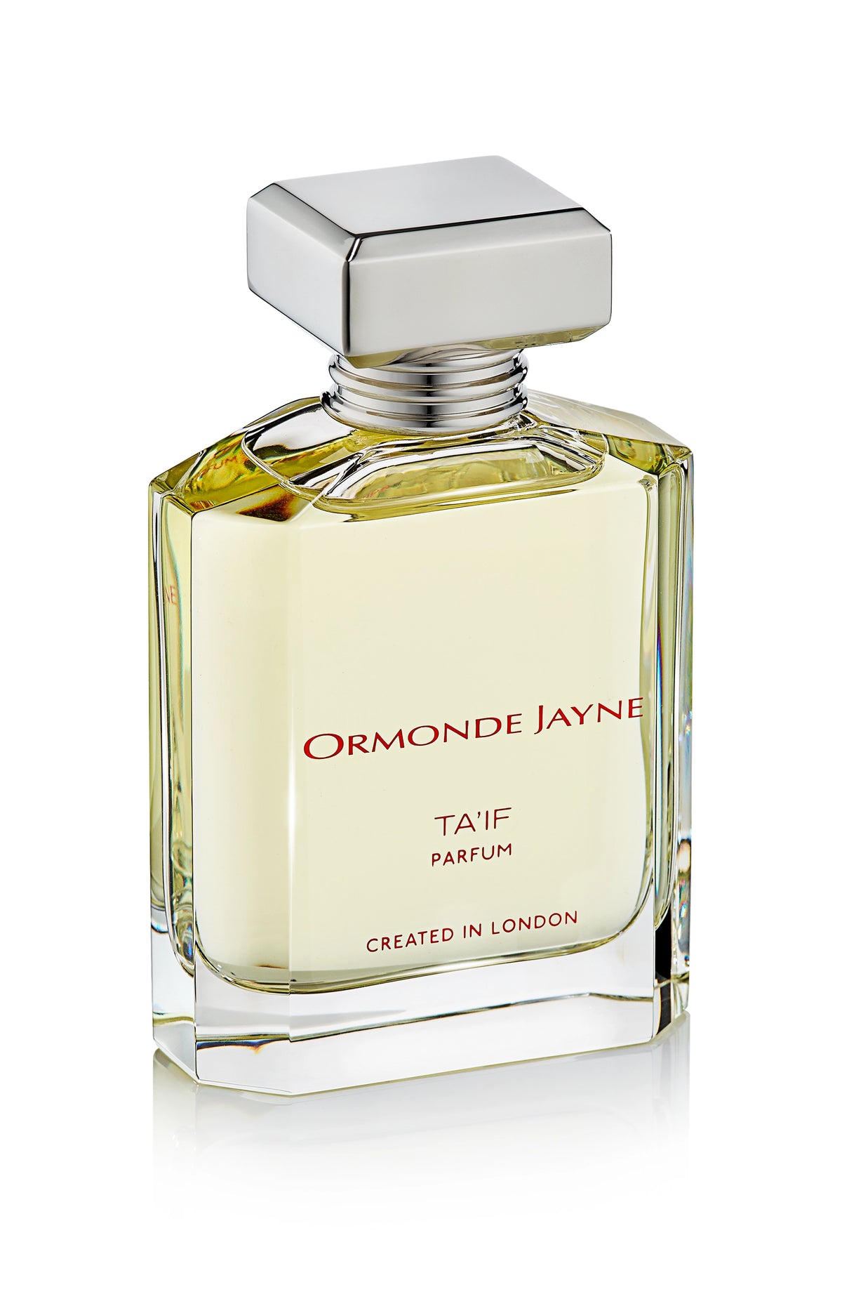 Clear glass perfume bottle with silver cap containing pale yellow Ta'if parfum