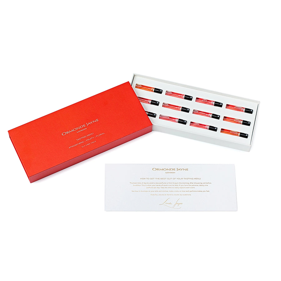 Red box containing ten small vials of atmospheric, fruity, and floral tasting menu samples with descriptive card