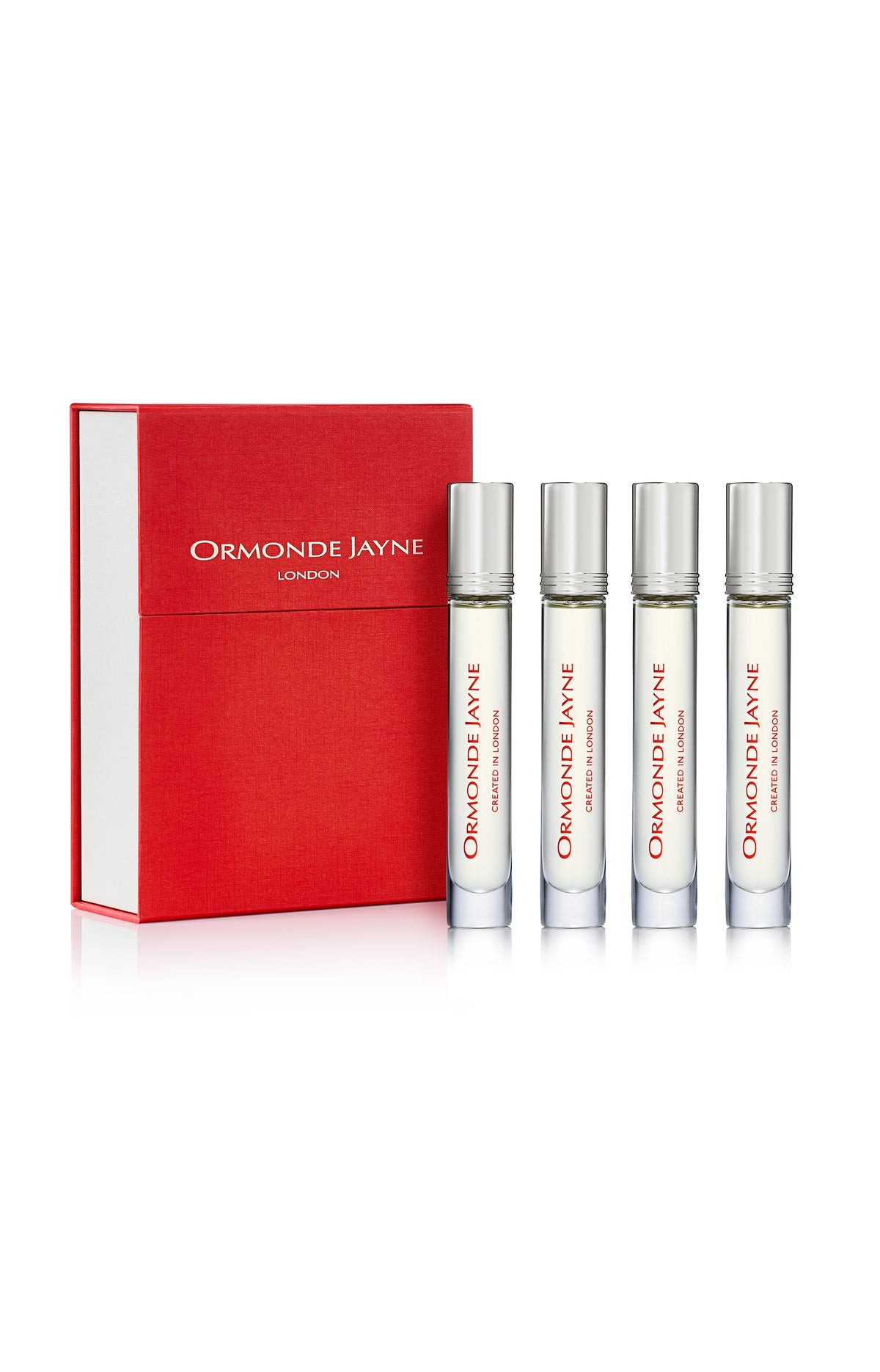 Set of four clear glass perfume vials with silver caps and red text, alongside a red box