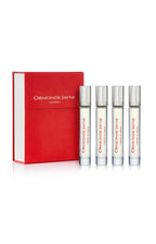 Set of four clear glass perfume vials with silver caps and red text, alongside a red box