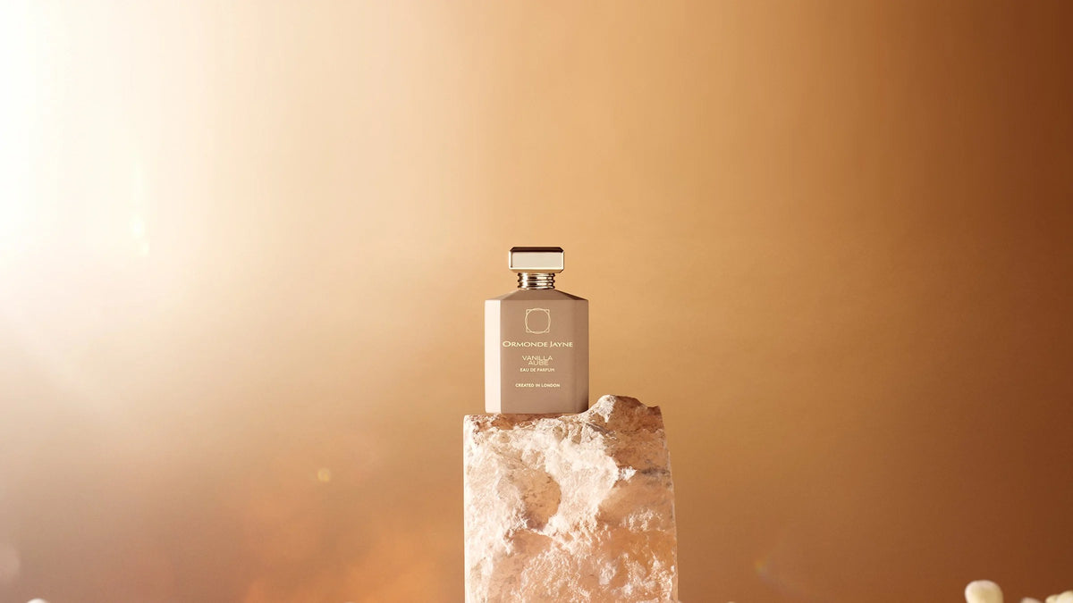 Ormonde Jayne Vanilla Aube eau de parfum bottle on a pale stone block in warm dawn light