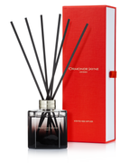 Black scented reed diffuser in glass bottle with silver collar and red rectangular box packaging