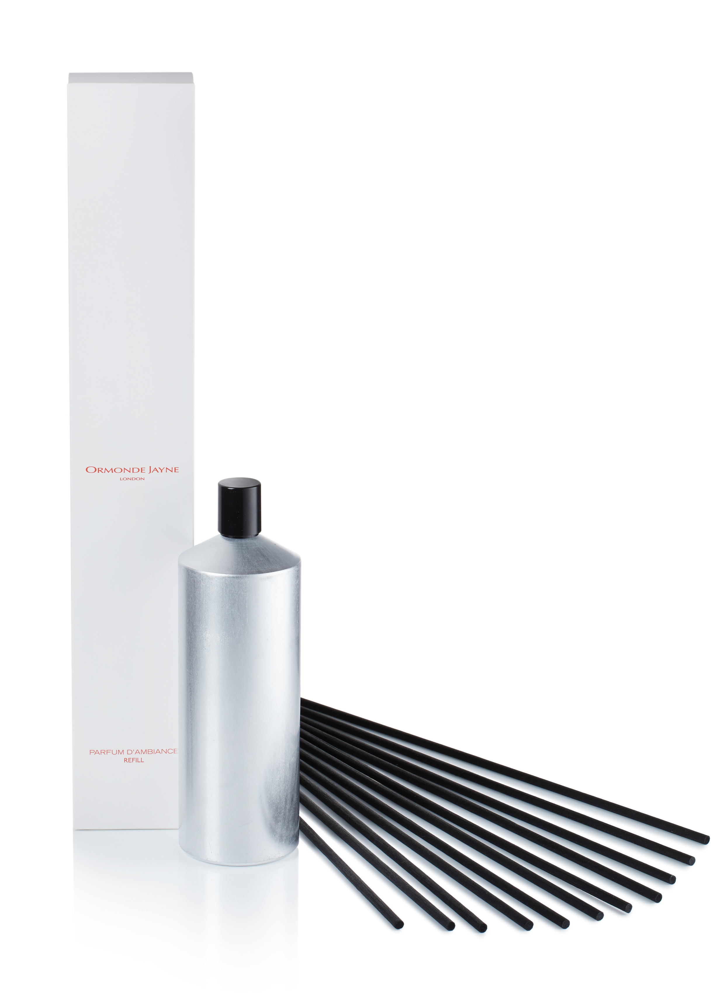 Silver cylindrical diffuser bottle with black reeds and tall white packaging box