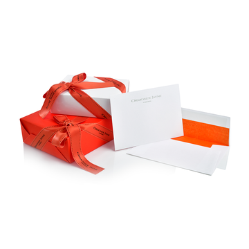 White and red gift boxes with red ribbons and white cards with envelopes for gift wrapping