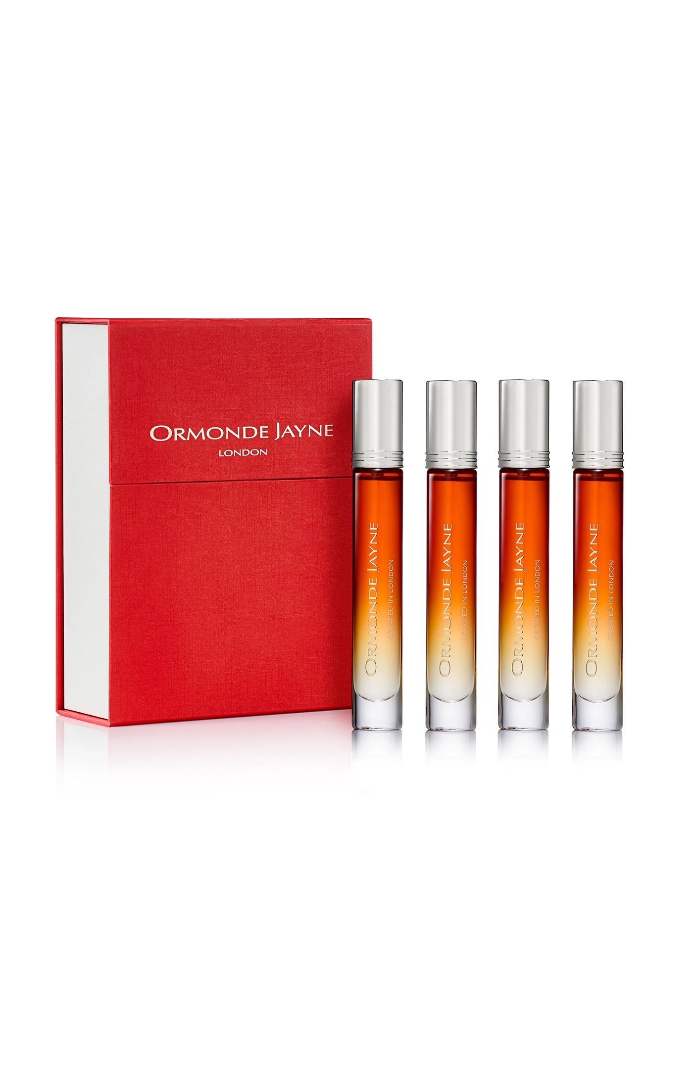 Set of four orange gradient travel perfume sprays with silver caps beside a red Ormonde Jayne London box